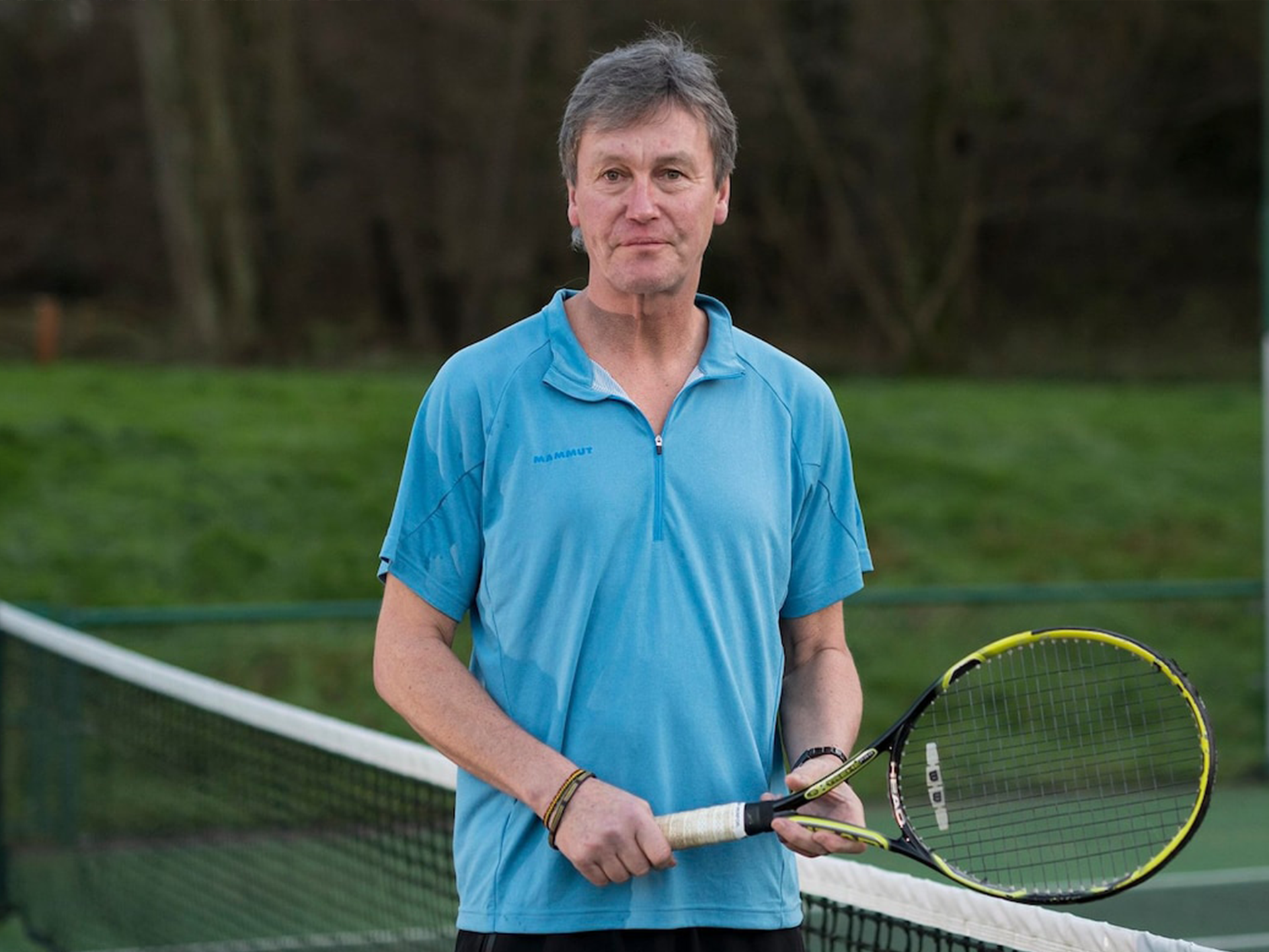 Paul holding tennis racket