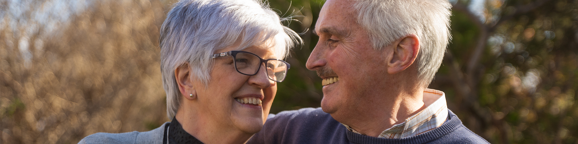 Couple outside smiling at eachother