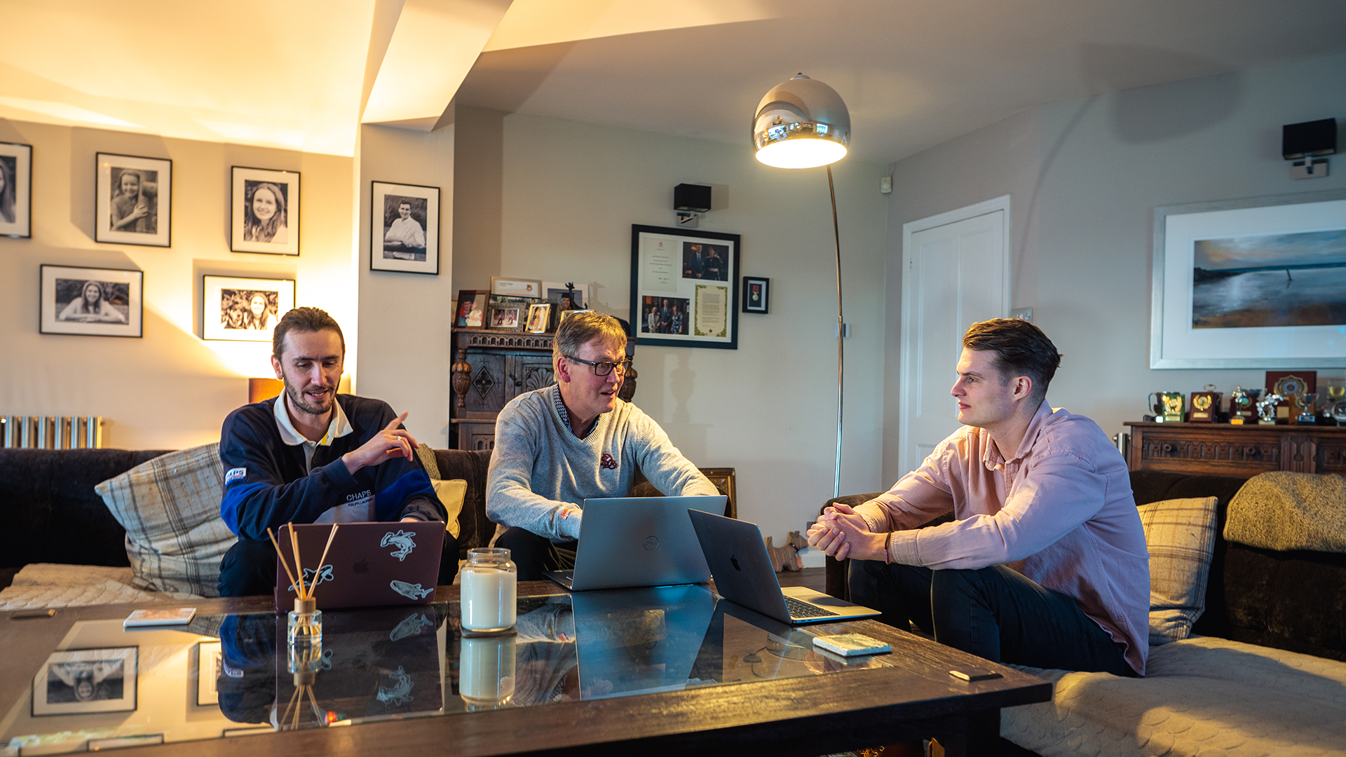 Dave paul ben sitting on sofa with laptops