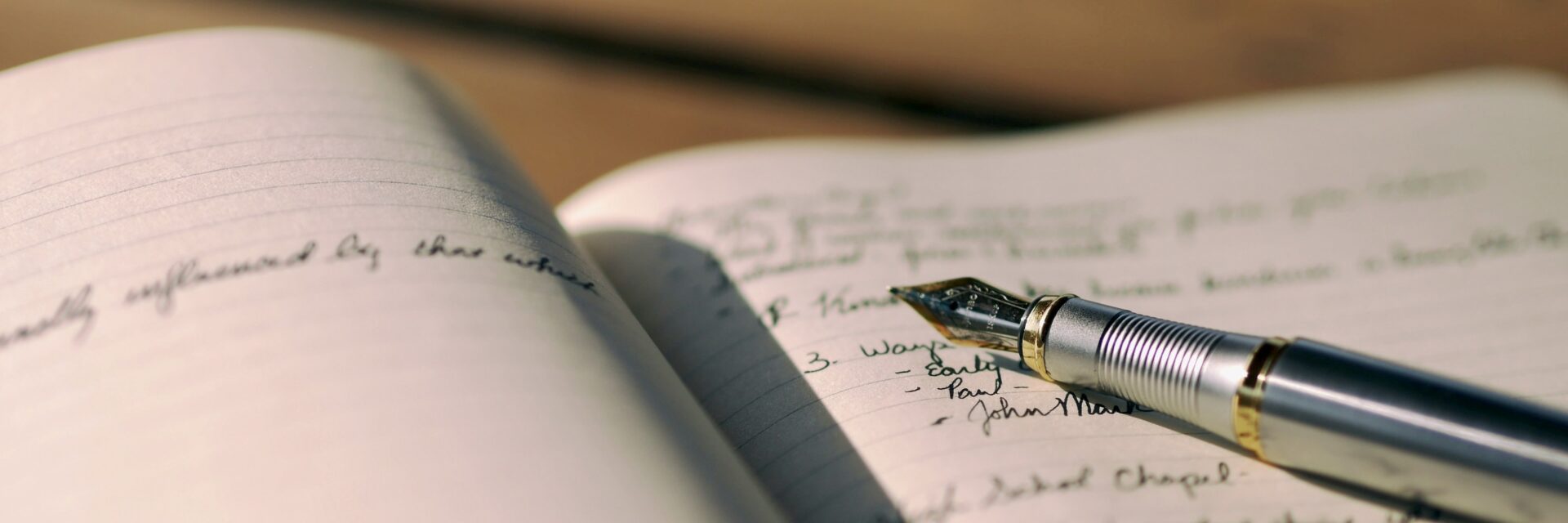 A fountain pen resting on a journal