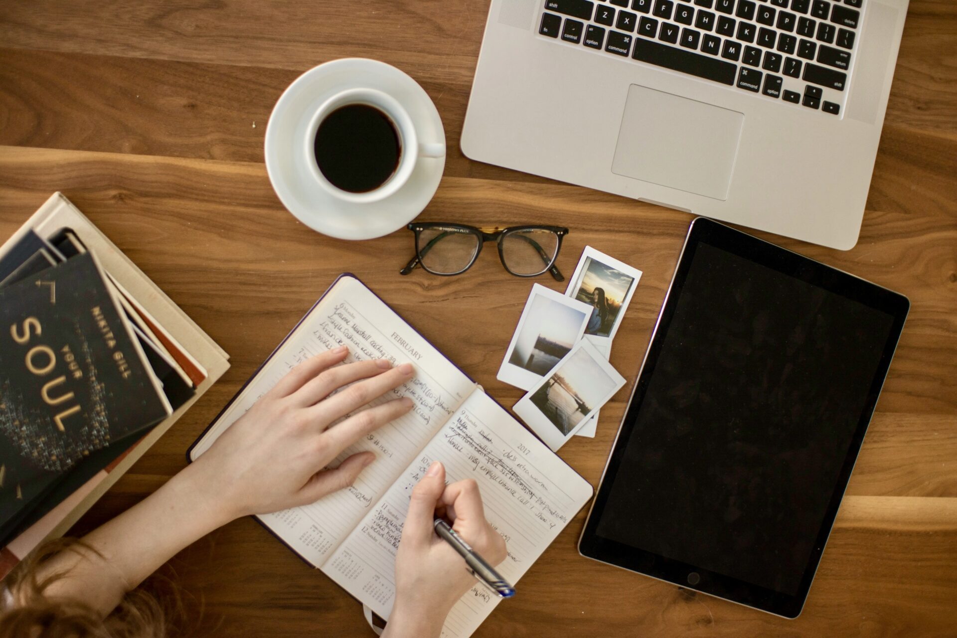 A person writing in journal at table