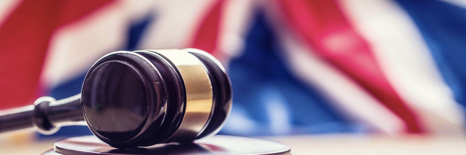 Gavel with british flag behind