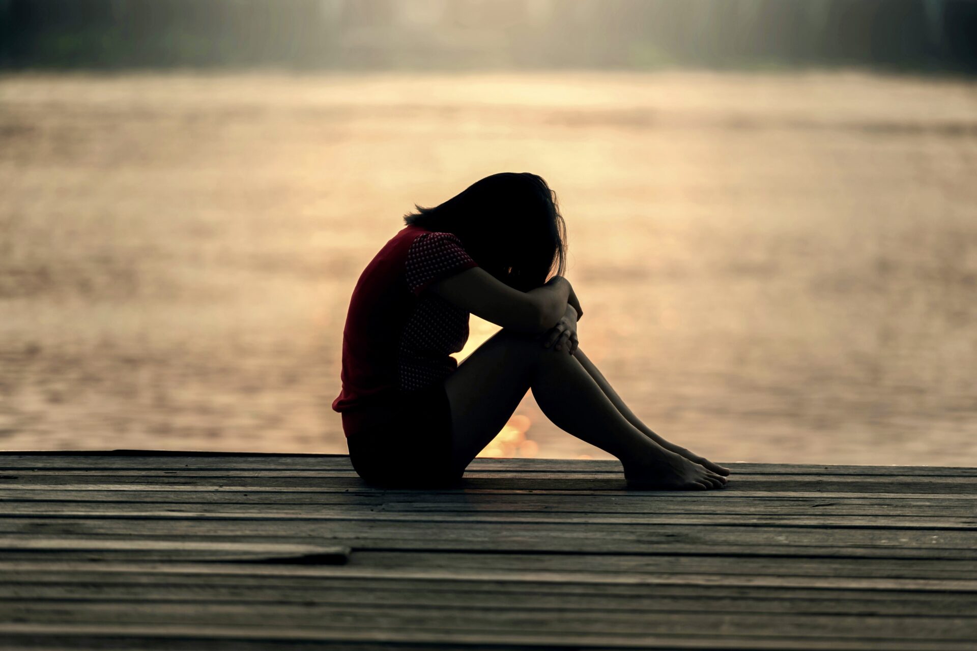 Grieving woman on a pier