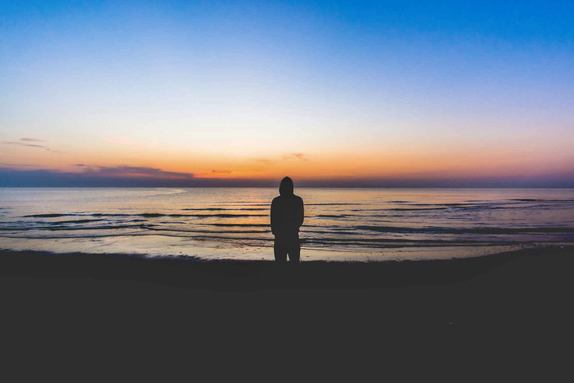 Person standing at sunset