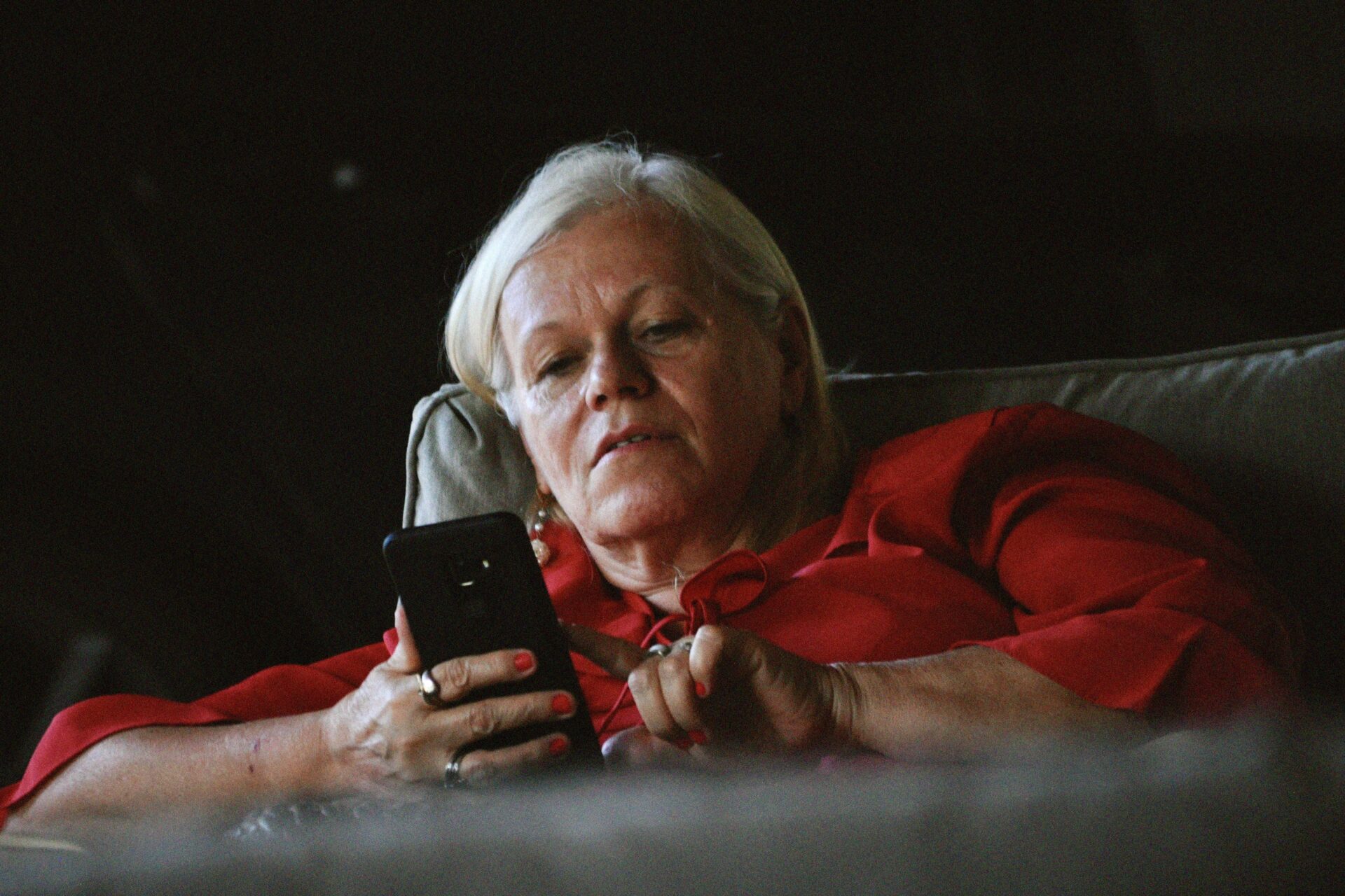 Person sitting on couch looking at phone