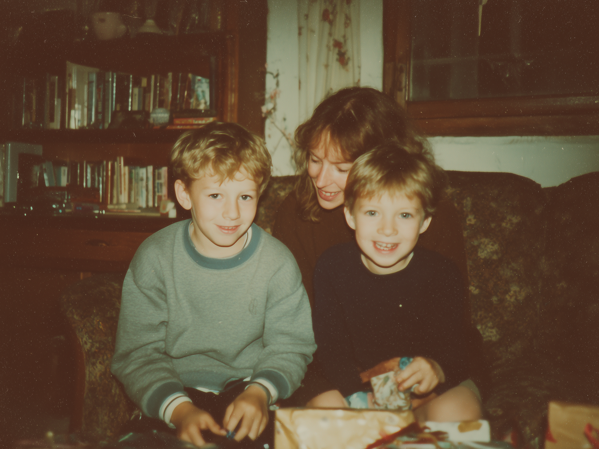 Nostalgic photo two young boys with parent sitting on sofa with presents