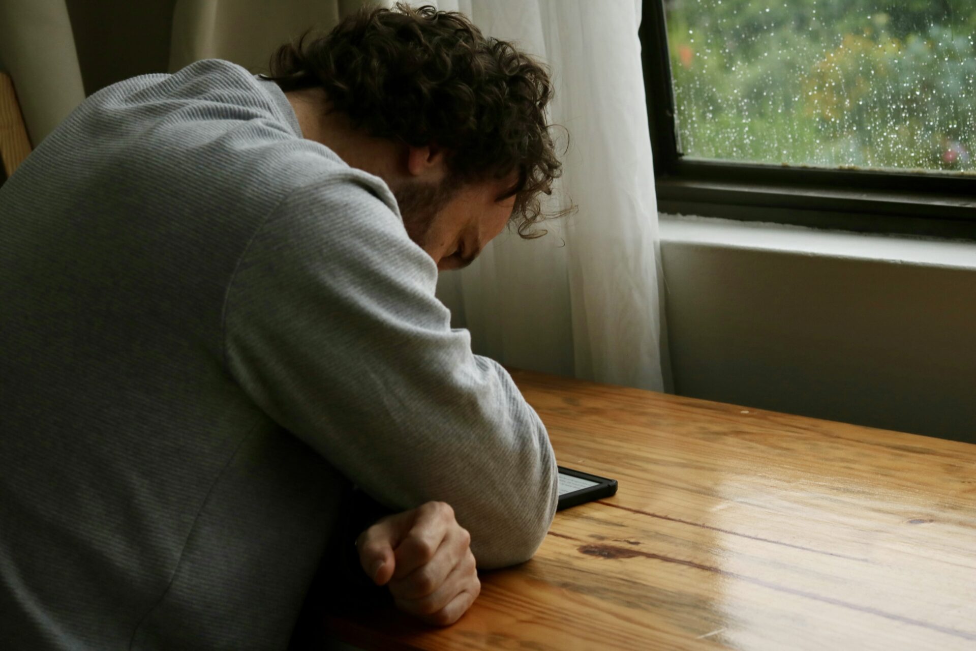 Obituary Examples: Thoughtful Templates & Tips 7 Person hunched at desk