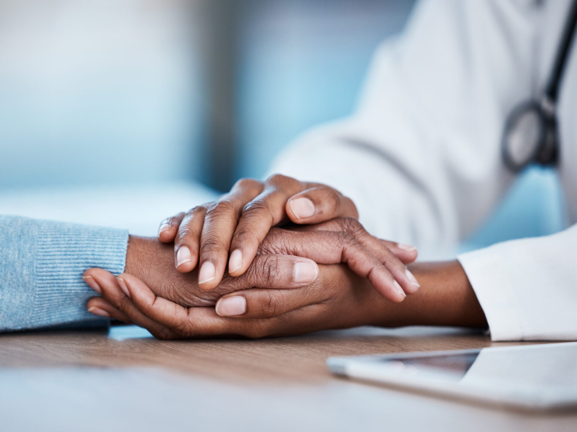 Doctor holding patients hand